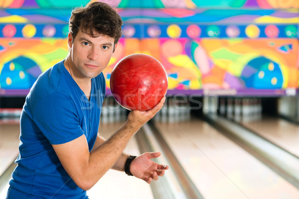 Young man bowling having fun Stock photo © Kzenon