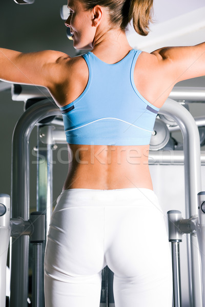 Woman working out in gym Stock photo © Kzenon