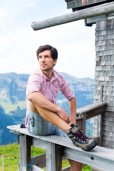 Alps - Man on mountains sitting at cabin in tirol Stock photo © Kzenon