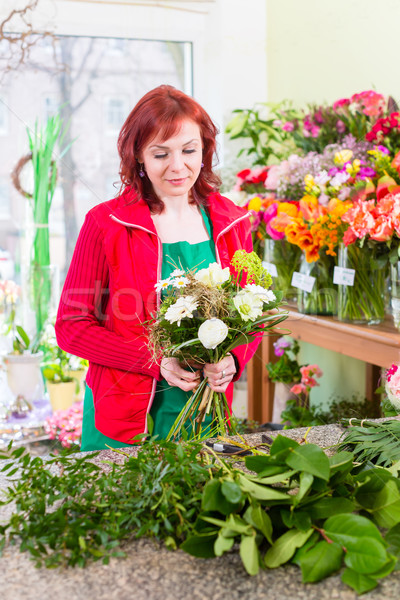 Florist binding flower bunch in shop  Stock photo © Kzenon