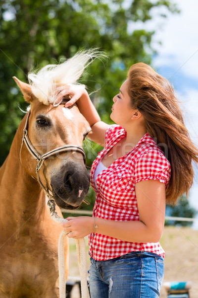 Woman petting horse on pony farm Stock photo © Kzenon