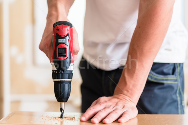 Stock photo: Craftsman or DIY man working with power drill