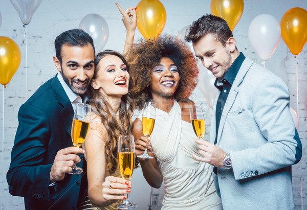 Group of party people celebrating with drinks Stock photo © Kzenon
