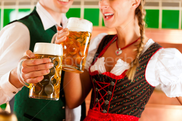 Man and woman with beer glass in brewery Stock photo © Kzenon
