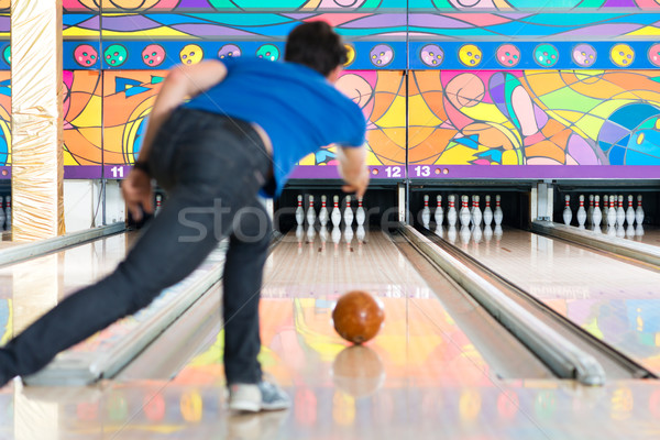 Young man bowling having fun Stock photo © Kzenon