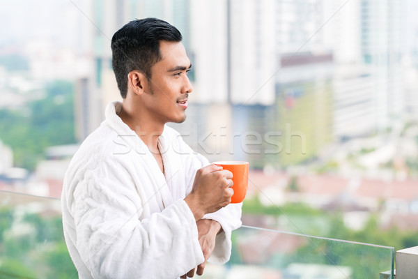 Asian man in morning front of city skyline Stock photo © Kzenon