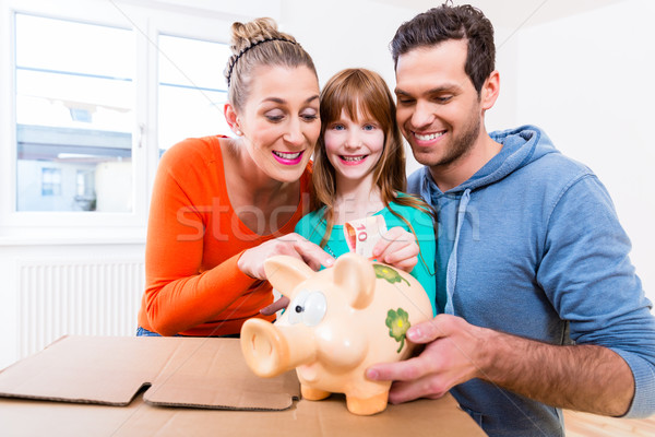 Family saving money by moving house Stock photo © Kzenon