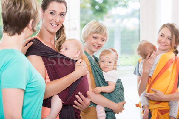 Group of women learning how to use baby slings for mother-child  Stock photo © Kzenon