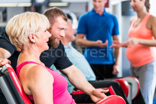 senior woman in group with pregnant woman working out at the gym Stock photo © Kzenon