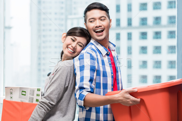 Young indonesian couple carrying moving boxes  Stock photo © Kzenon