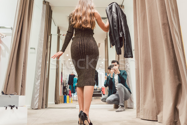 Man making photo of his wife with her new dress in fashion store Stock photo © Kzenon