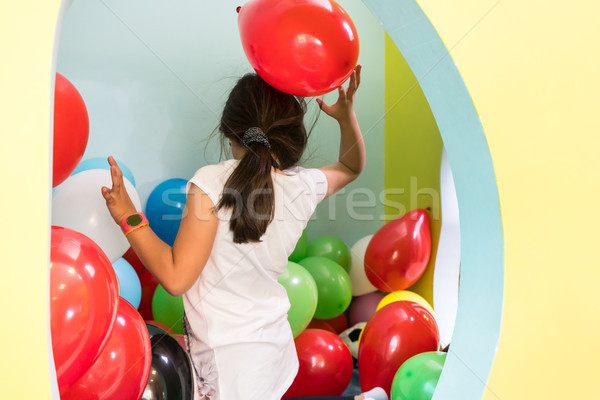 Cute girl playing with colorful balloons during playtime at the kindergarten Stock photo © Kzenon