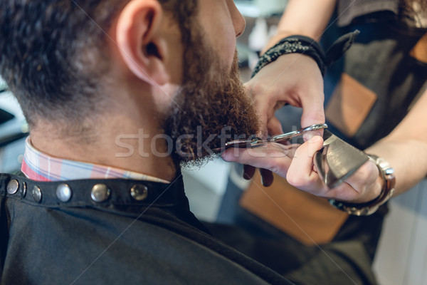 Close-up of the head of a young man and the hands of a hairstylist Stock photo © Kzenon