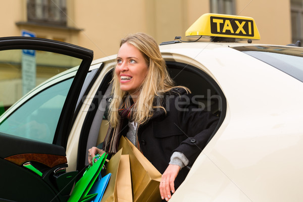 Young woman gets out of taxi Stock photo © Kzenon