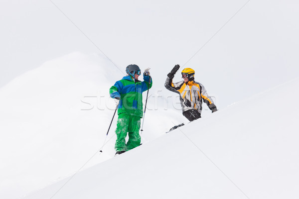 Skier and snowboarder in the snow Stock photo © Kzenon