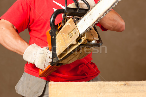 Construction worker with motor saw Stock photo © Kzenon