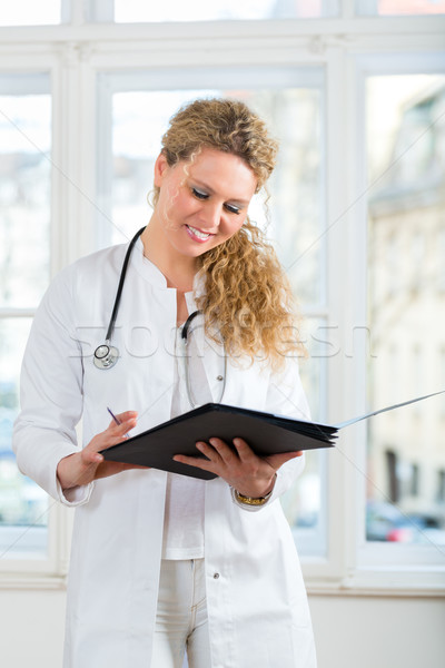 doctor with test result in document or dossier Stock photo © Kzenon