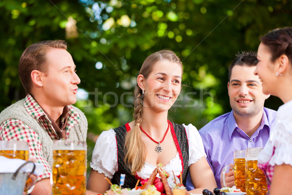 Two happy couple sitting in Beer garden Stock photo © Kzenon