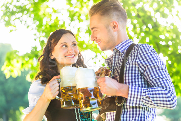 German couple in Tracht drinking beer Stock photo © Kzenon