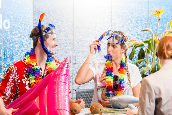 Man and woman booking beach holiday Stock photo © Kzenon