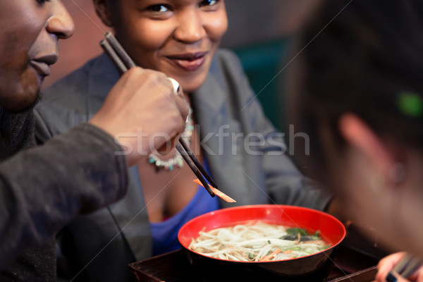 Friends eating noodle soup in Japanese Restaurant Stock photo © Kzenon