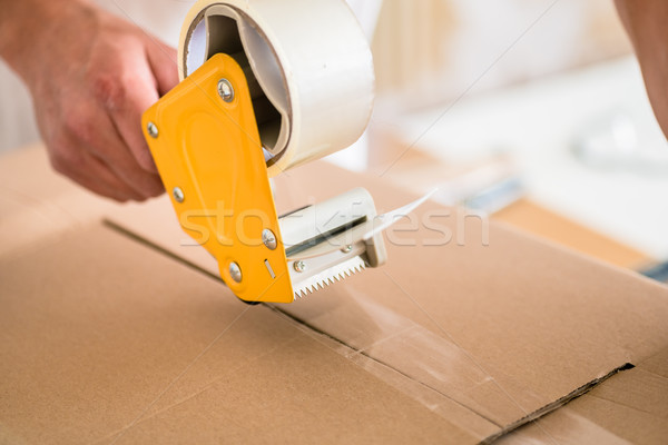Man taping packing case Stock photo © Kzenon