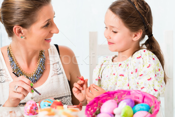 Family having fun coloring Easter eggs Stock photo © Kzenon