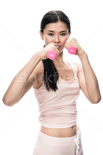 Fiatal határozott nő tart kicsi súlyzók Stock fotó © Kzenon