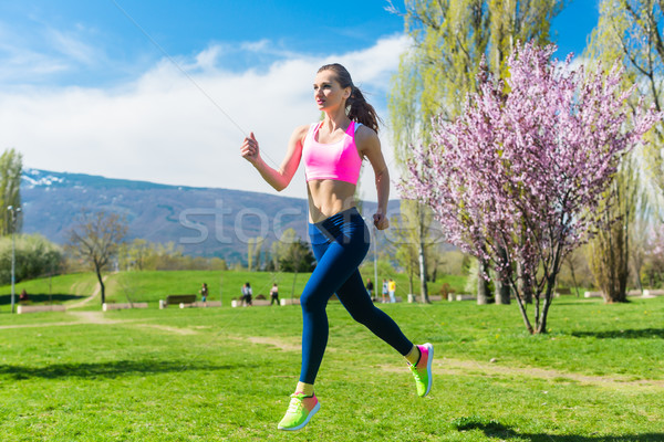 Woman running fast for sport on sunny day Stock photo © Kzenon