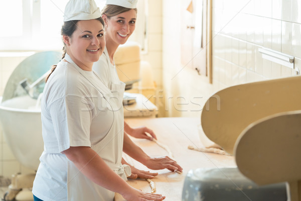 Baker women working in bakehouse of bakery Stock photo © Kzenon