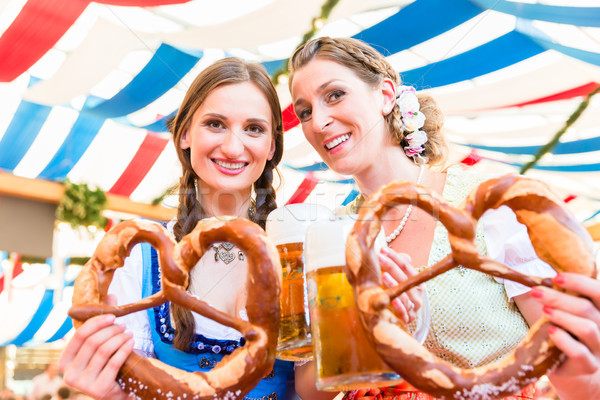 Friends at Bavarian Fair with giant pretzels Stock photo © Kzenon