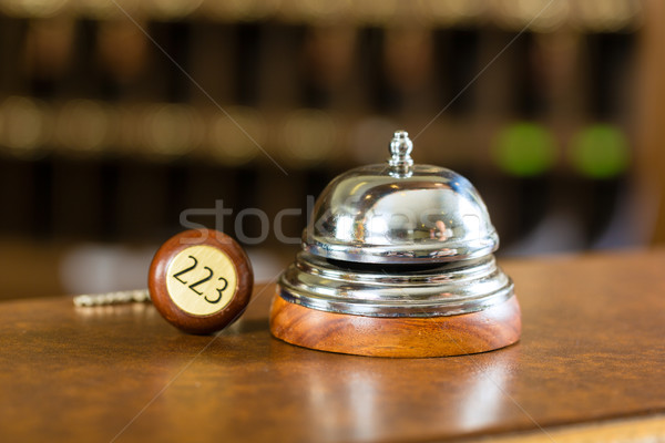 Reception - Hotel bell and key lying on the desk Stock photo © Kzenon