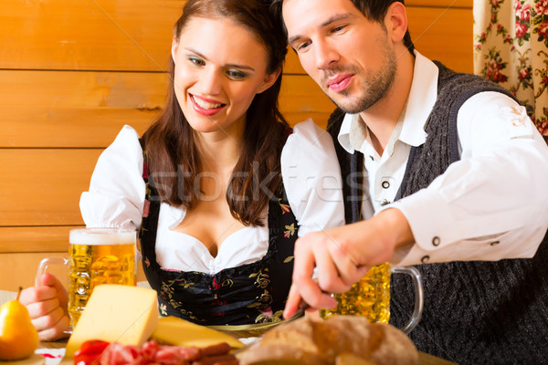 Young couple in a hunters cabin eating Stock photo © Kzenon