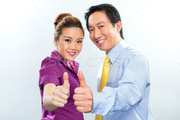 Motivated colleagues in Asian business office Stock photo © Kzenon