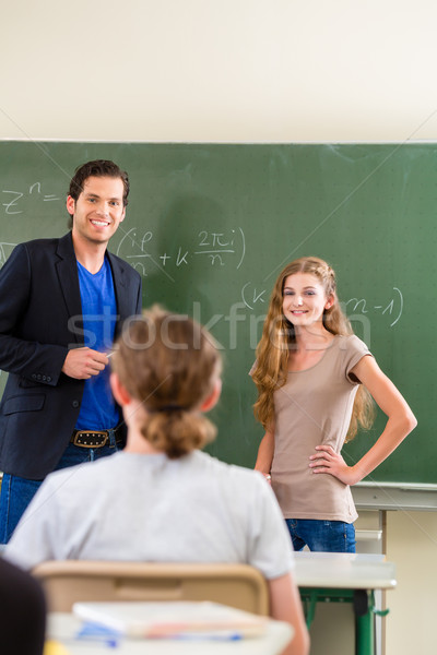 Teacher testing  student  in math lessons in school class Stock photo © Kzenon
