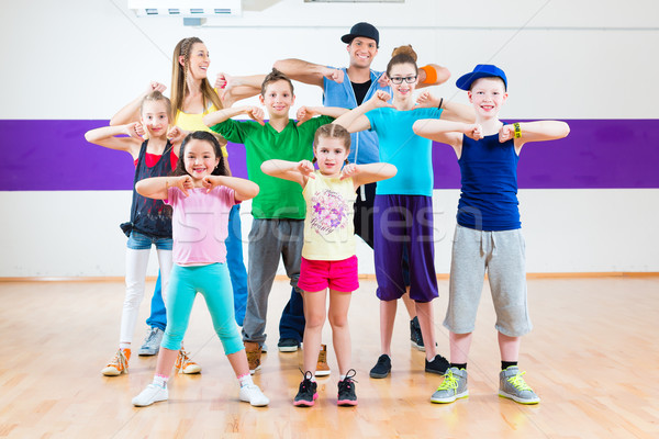 Stock photo: Dance teacher giving kids Zumba fitness class 