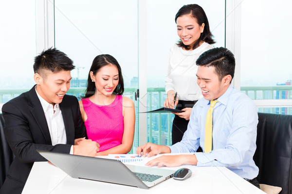 Asian banker team counseling couple in office Stock photo © Kzenon