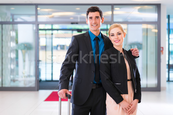 Man and woman arriving at hotel lobby with suitcase  Stock photo © Kzenon