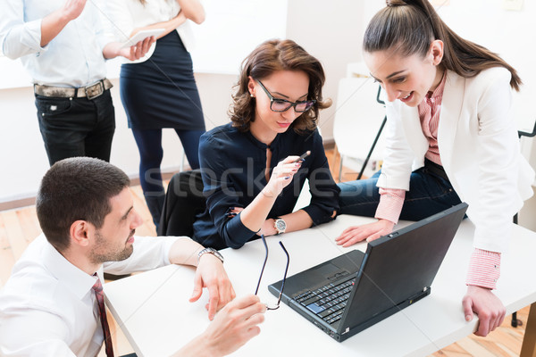 Team giving business report to boss in office Stock photo © Kzenon