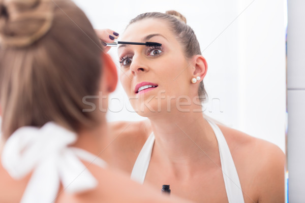 Nő smink szempilla fürdőszoba tükör szem Stock fotó © Kzenon