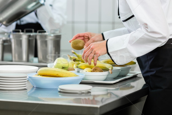 Chef preparing plates in canteen kitchen Stock photo © Kzenon