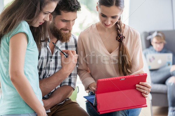 Reliable digital nomads helping their co-worker during remote wo Stock photo © Kzenon