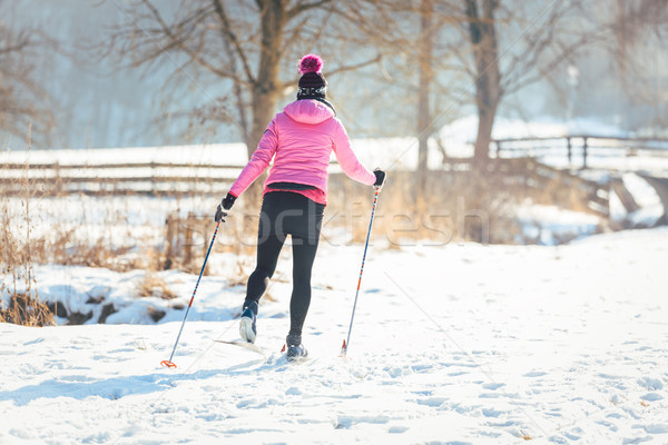 Woman doing cross country skiing as winter sport Stock photo © Kzenon