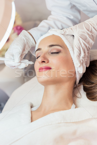 Beautiful woman relaxing during non-invasive facial treatment Stock photo © Kzenon