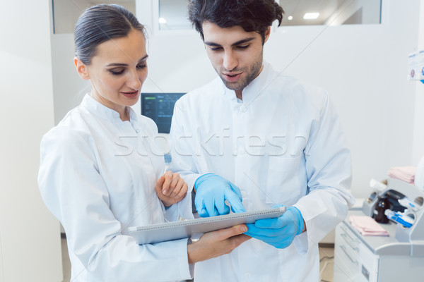 Two doctors as team looking at tablet computer data Stock photo © Kzenon