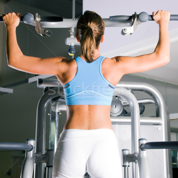 Woman working out in gym Stock photo © Kzenon