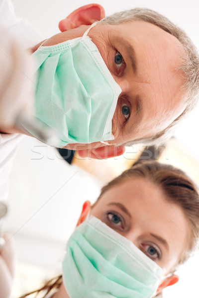 Dentist, Assistant and drill in a treatment Stock photo © Kzenon