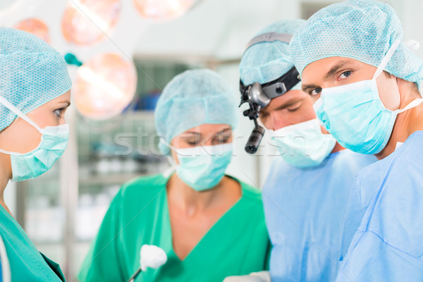 Surgeons operating in operation theater room Stock photo © Kzenon