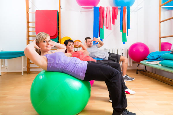 Patients at physiotherapy on training balls Stock photo © Kzenon