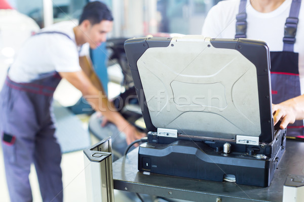 Car mechanics with diagnosis tool in Asian auto workshop Stock photo © Kzenon